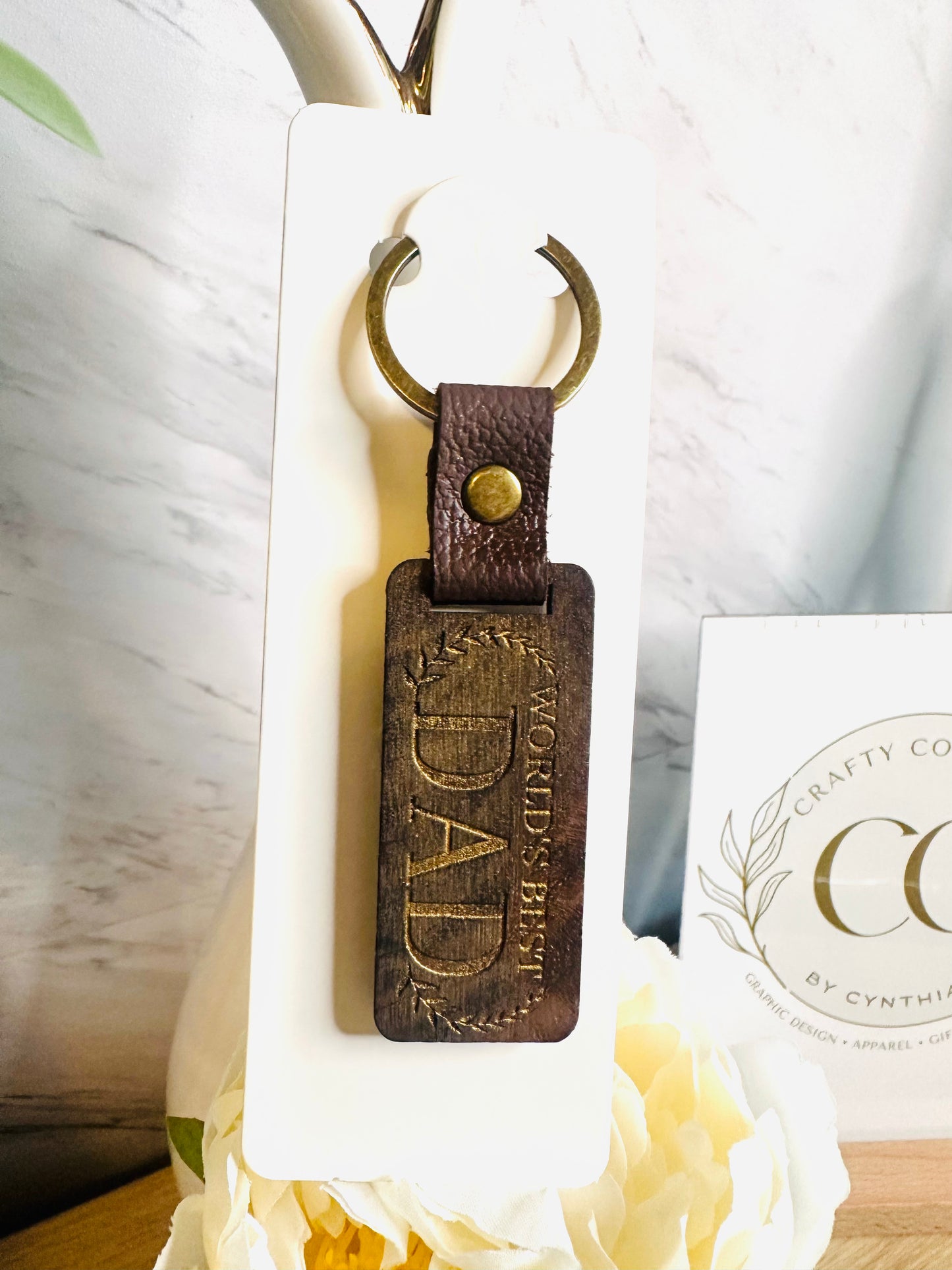 Laser engraved World’s Best Dad keychain with optional personalized names on the back displayed inside luxury Father’s Day gift box