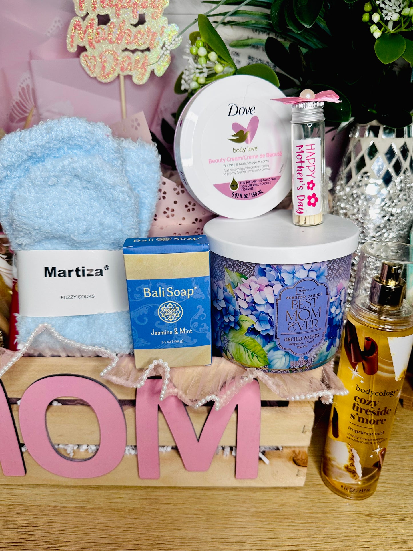 Best Mom Ever scented candle with decorative match jar, fuzzy socks, body cream, artisan soap, body mist and floral Mother’s Day spa gift box.