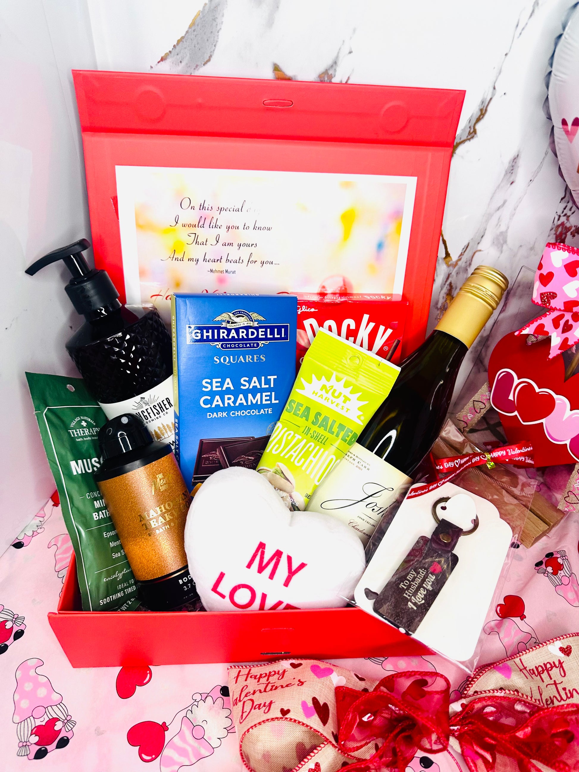 Luxury Valentine's Day gift box for men featuring Josh Cellars wine, Ghirardelli chocolates, mahogany teakwood body care, and a 'To My Husband' keychain in a red gift box.