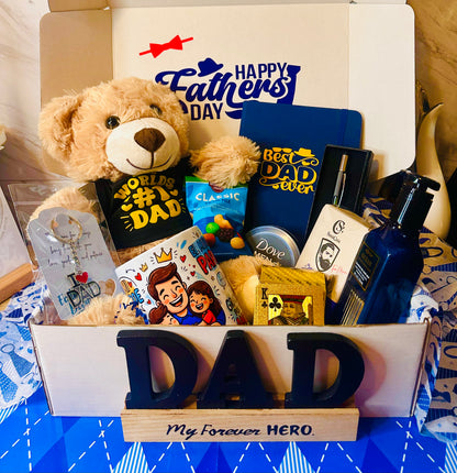Gift basket for Father's Day with teddy bear, cards, and small items on a blue tablecloth.