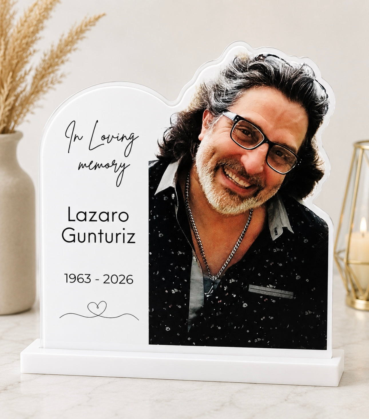 Personalized acrylic memorial plaque shaped like a tombstone, featuring a printed portrait with the text 'In Loving memory' and years, displayed on a white crystal acrylic .