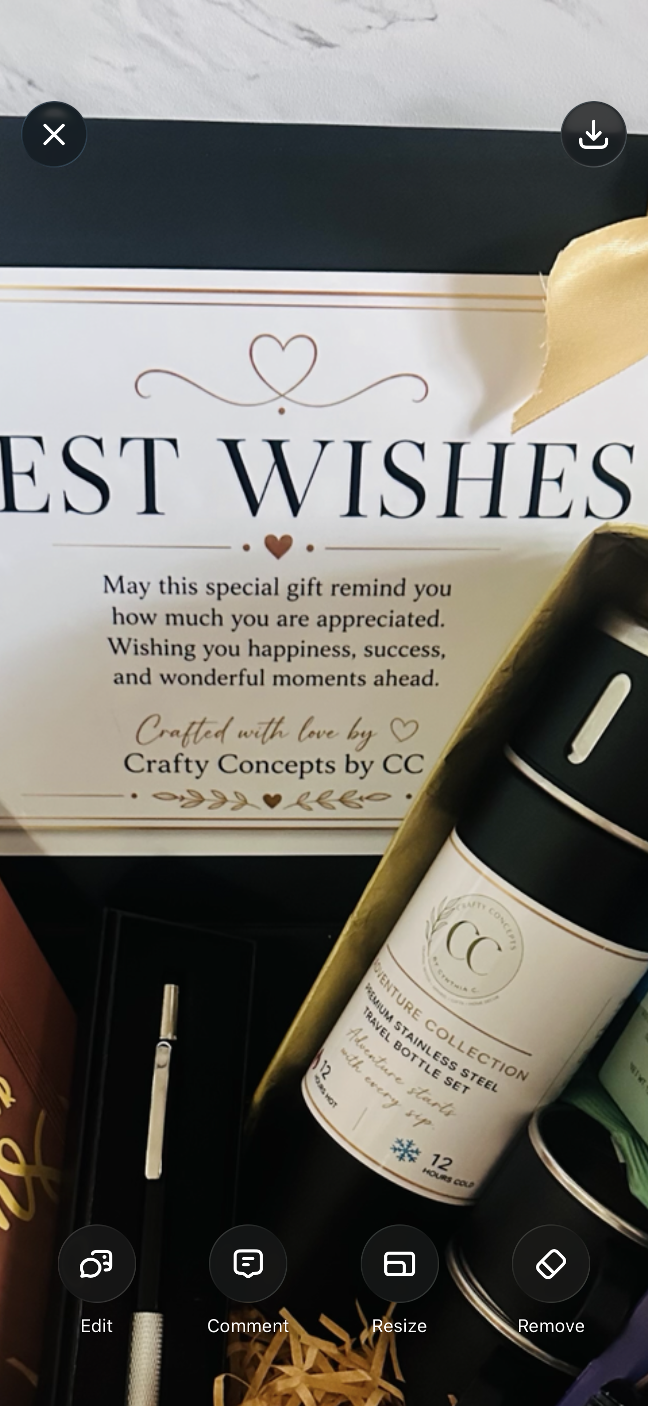 A gift box arrangement featuring a white card that reads 'BEST WISHES' with a message of appreciation, alongside a black and white bottle from Crafty Concepts by CC, a gold ribbon, and a pen.