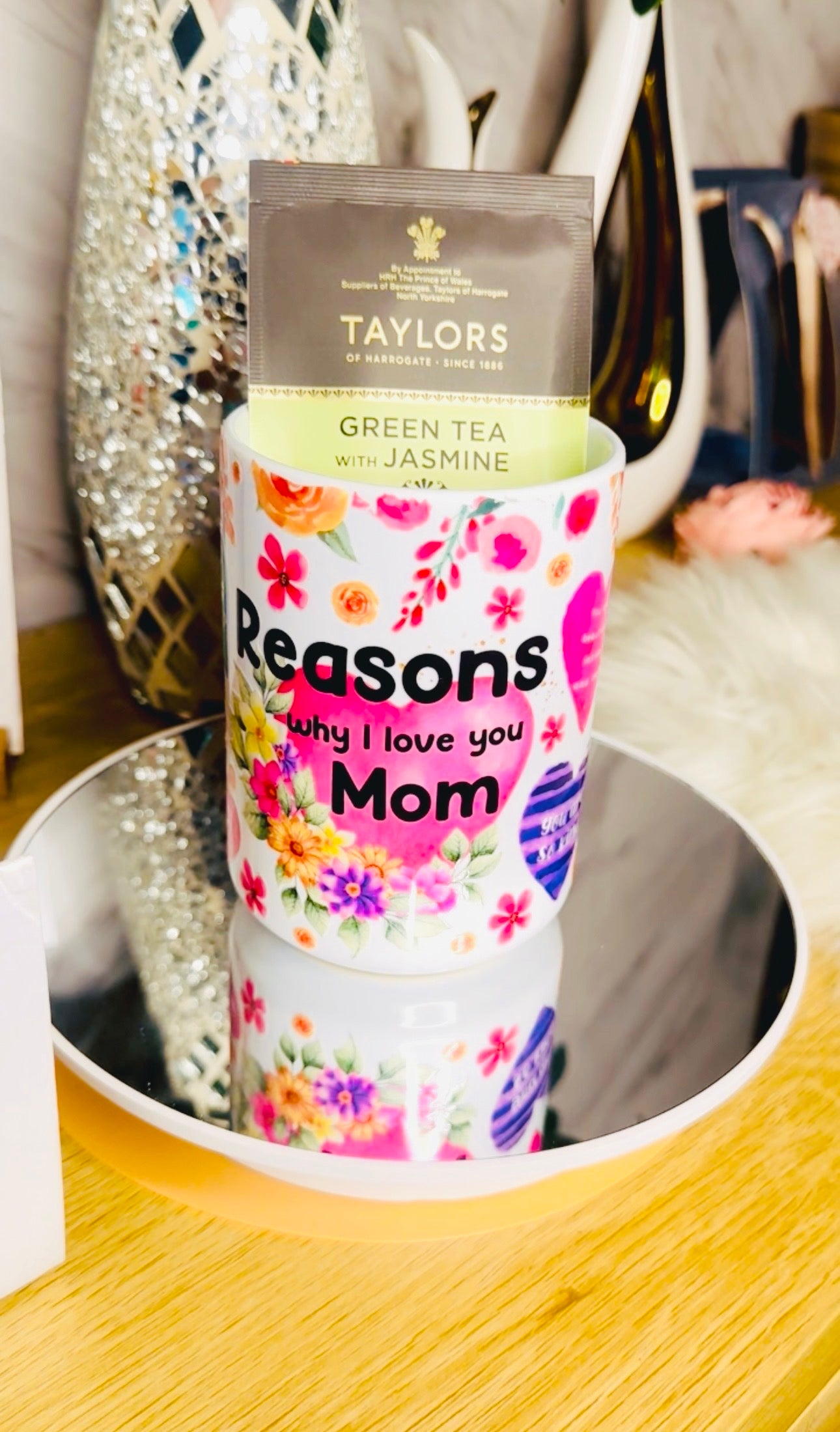 Custom ceramic floral mug with 'Reasons Why I Love You Mom' text, part of a Mother's Day gift set.