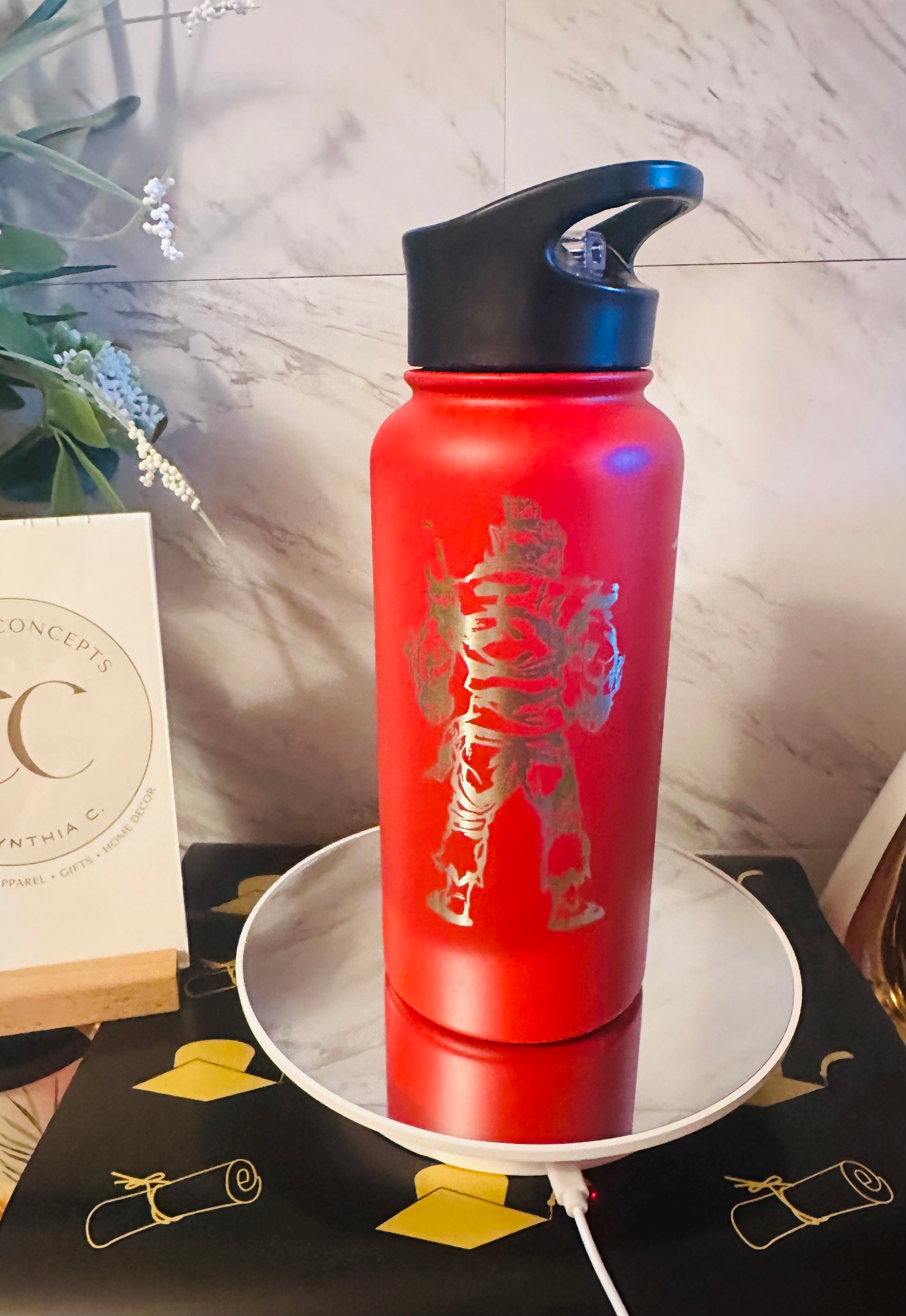 Red 32oz insulated water bottle with black flip straw lid, laser engraved with the name Alexander in a custom vertical font
