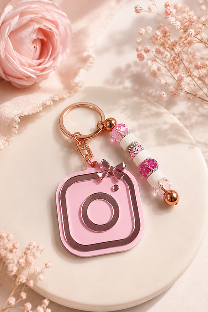 Custom pink acrylic NFC keychain with Instagram-inspired design, rose gold hardware, and decorative beads for sharing social media, business contact information, and websites