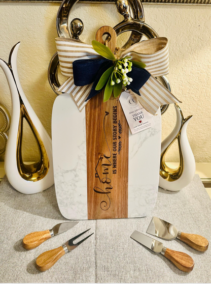 Personalized marble and acacia cutting board engraved “Home Is Where Our Story Begins” — housewarming keepsake by Crafty Concepts.