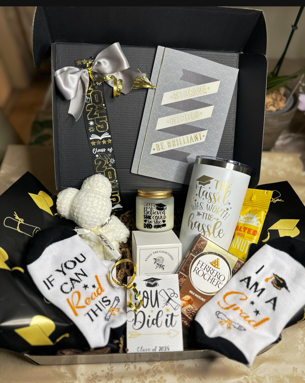  Black and gold graduation gift box with engraved Tassel Was Worth the Hassle tumbler, scented candle, grad socks, towel bear, journal and treats