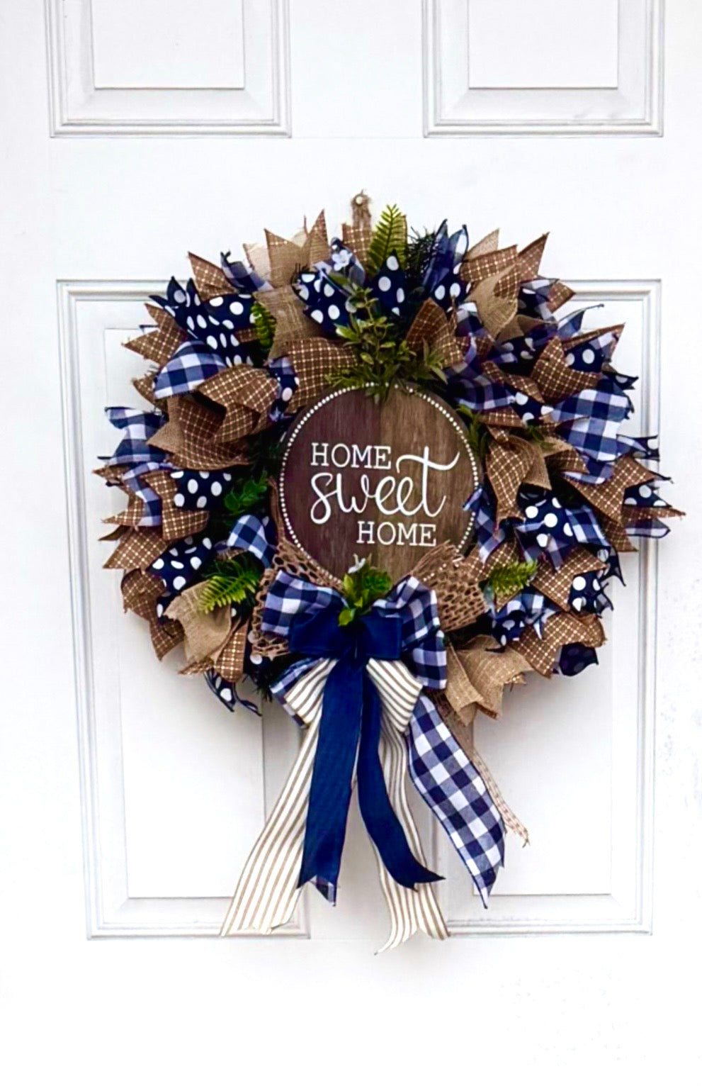 Handcrafted navy and gold 'Home Sweet Home' wreath displayed on a white front door, showing its large scale and how the deco mesh colors pop against a home exterior.