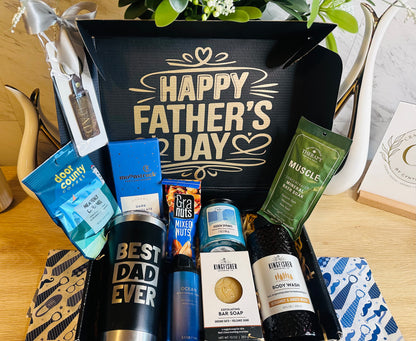 Luxury Father’s Day gift basket featuring personalized Best Dad Ever tumbler, laser engraved World’s Best Dad keychain, gourmet coffee, chocolate, candle, body wash, self-care items, and premium snacks in elegant black gift box.