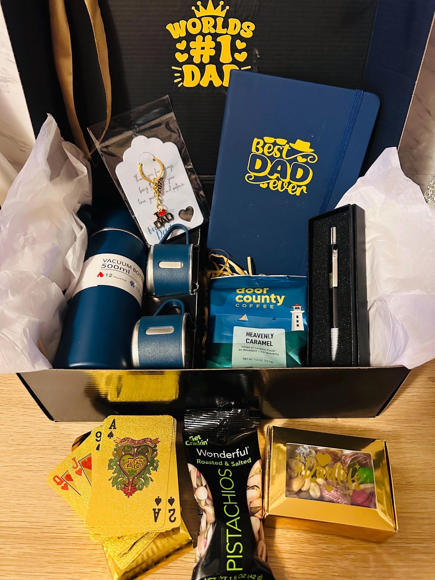 Worlds #1 Dad gift box hamper with 500ml insulated flask thermos with two cups.  Best Dad Ever notebook, pen gift set, Door County caramel coffee, pistachios, gold foil playing cards, and a Dad Life candy box.