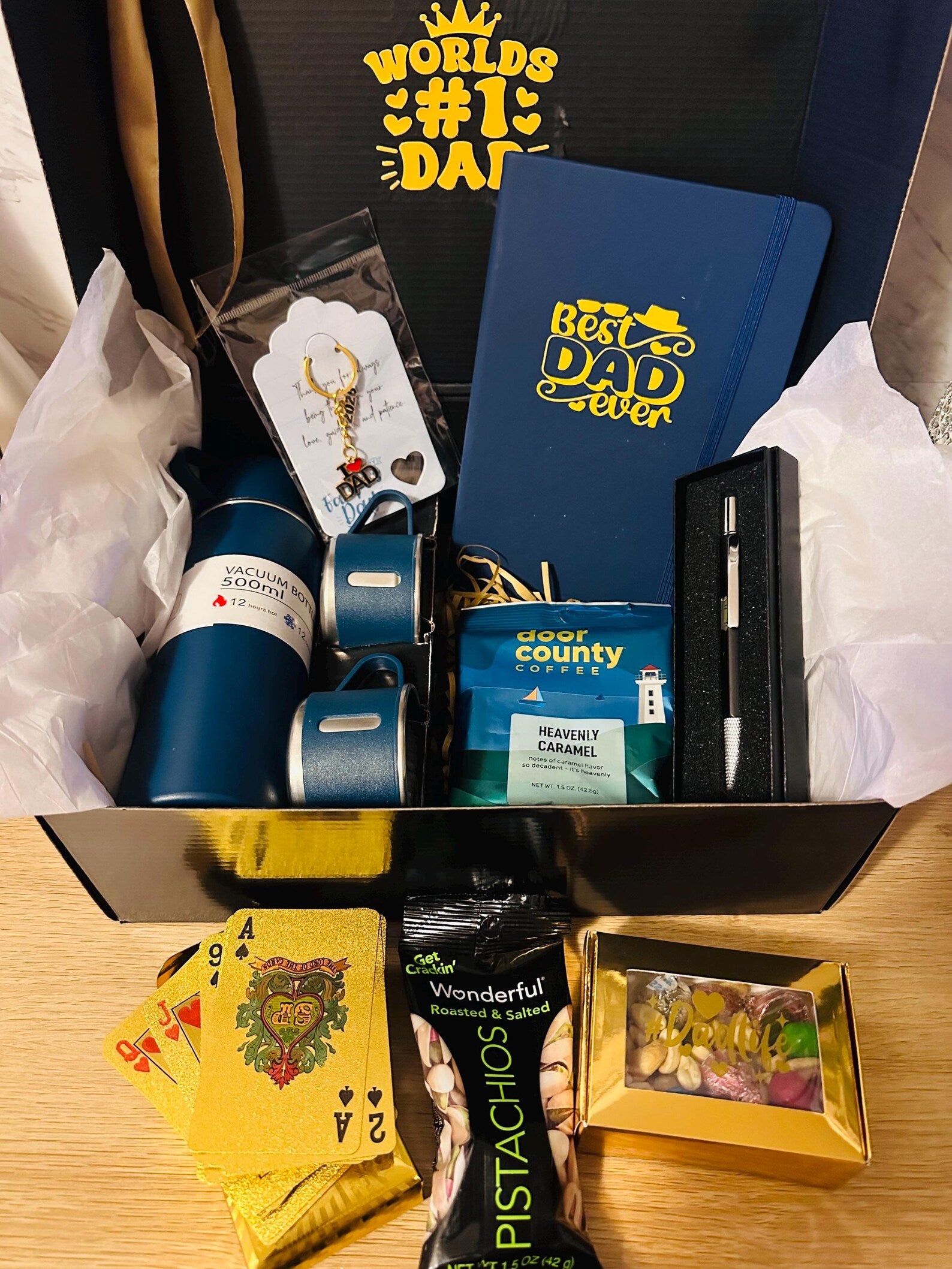 Worlds #1 Dad gift box hamper with 500ml insulated flask thermos with two cups.  Best Dad Ever notebook, pen gift set, Door County caramel coffee, pistachios, gold foil playing cards, and a Dad Life candy box.