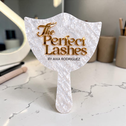 Pearlescent handheld acrylic mirror with raised gold logo for The Perfect Lashes