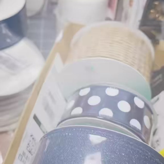 A close-up video showcase of a handmade 'Home Sweet Home' door wreath. The video highlights the textures of the navy and gold deco mesh, the shimmering gold-edged ribbons, and the intricate details of the multi-layered buffalo check bow and decorative blue berries