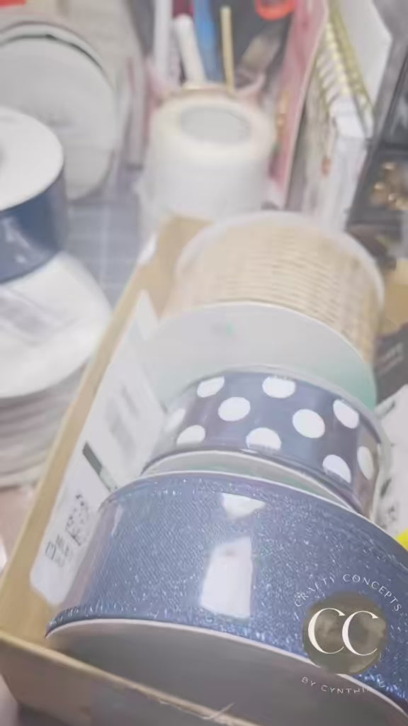 A close-up video showcase of a handmade 'Home Sweet Home' door wreath. The video highlights the textures of the navy and gold deco mesh, the shimmering gold-edged ribbons, and the intricate details of the multi-layered buffalo check bow and decorative blue berries